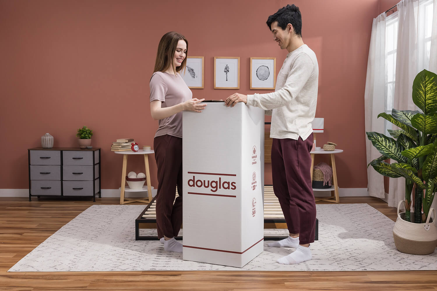 A couple unboxing a Douglas mattress in their bedroom