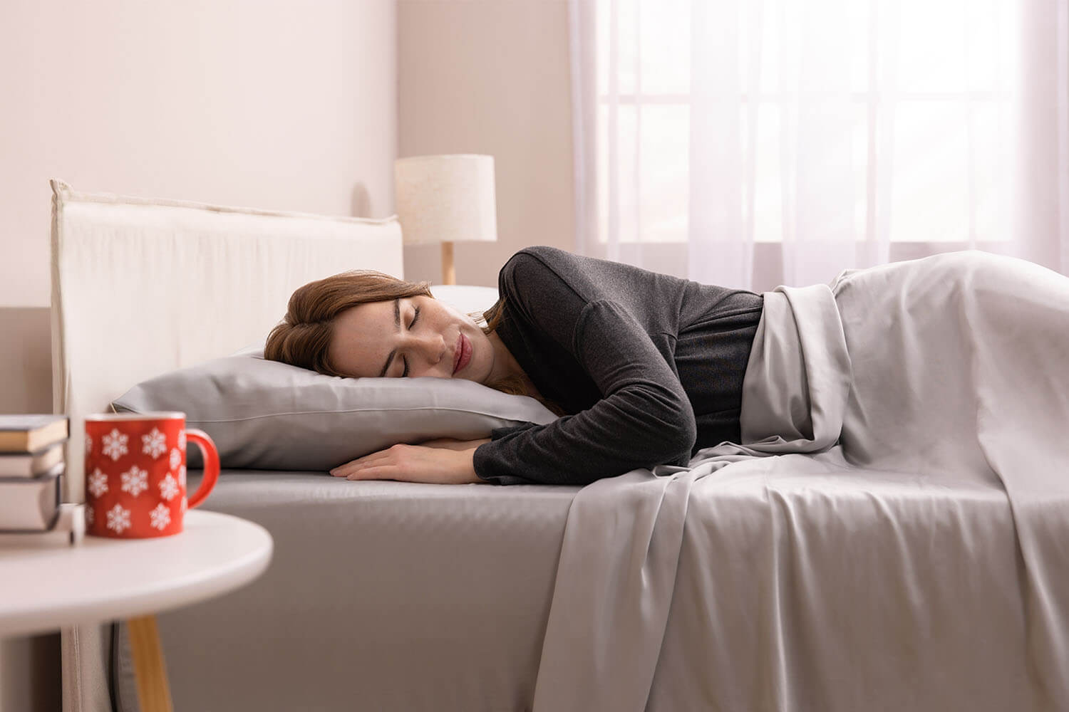 Woman sleeping peacefully on a bed with cooling Bamboo Sheets