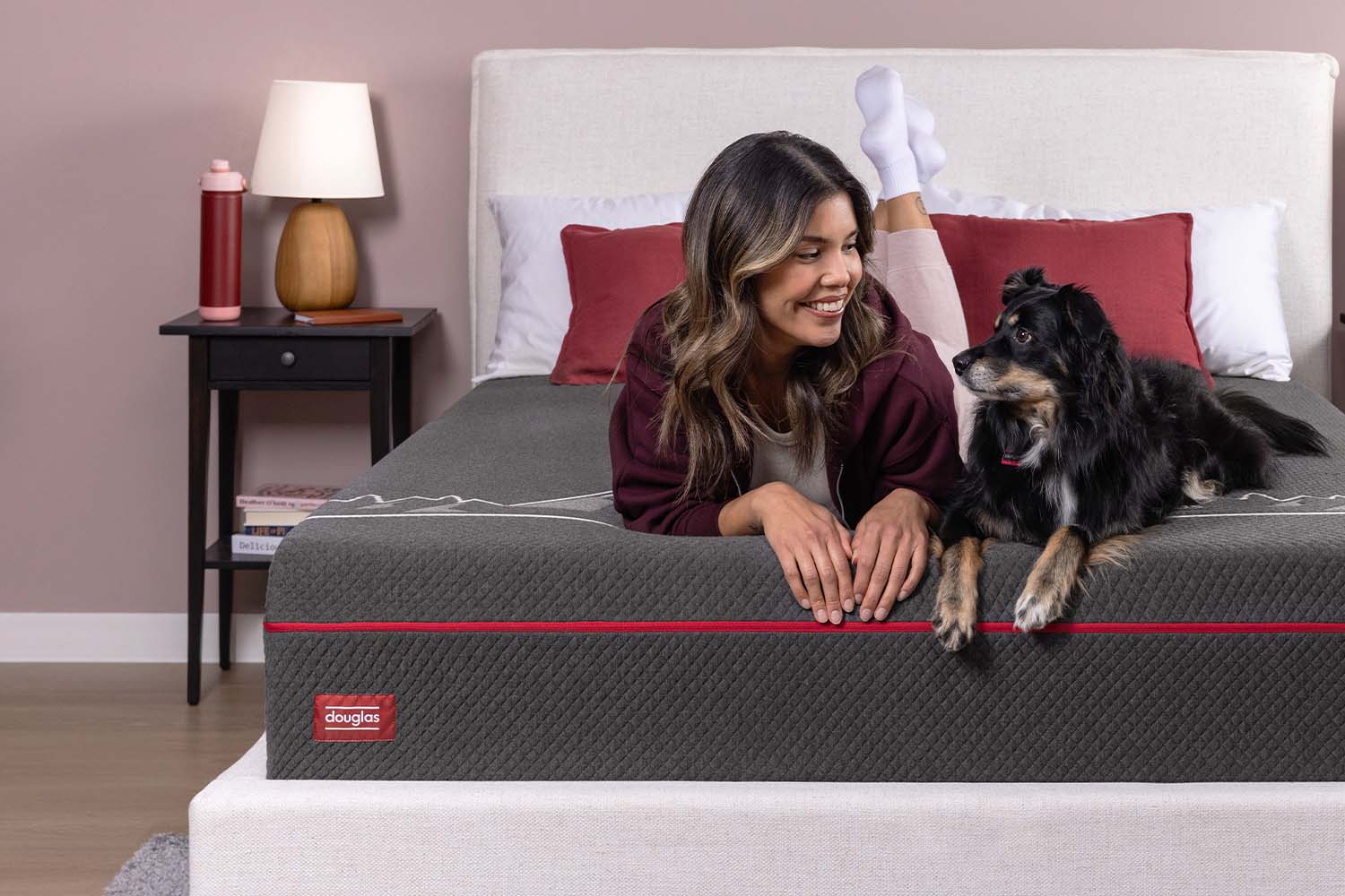 Woman opening the shipping box for her Douglas Alpine Hybrid mattress