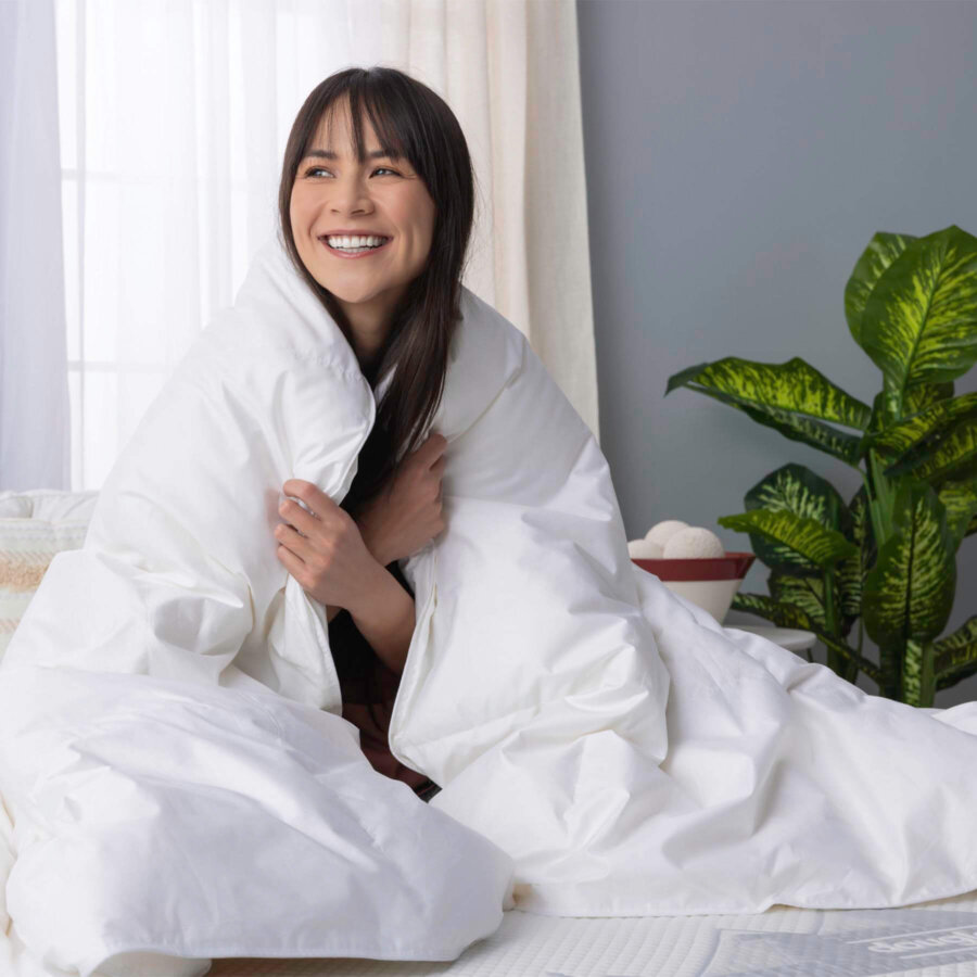Woman on bed wrapped in Douglas Down Duvet Comforter