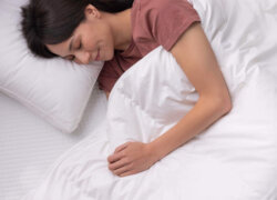 Woman in bed sleeping under Douglas Down Duvet