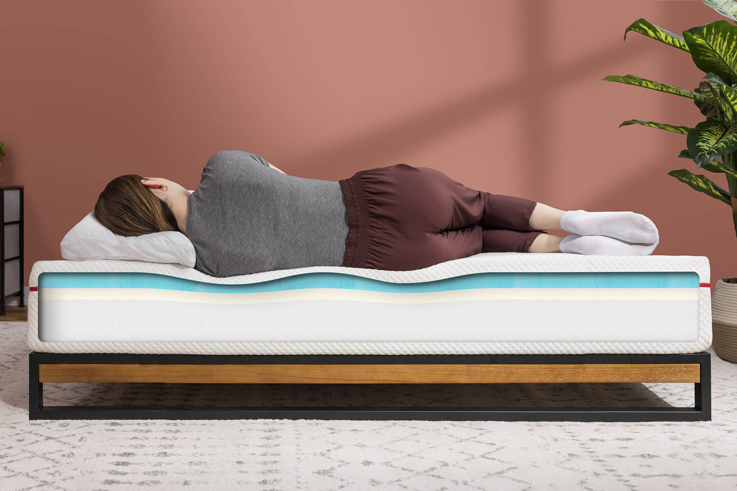 A woman sleeps on her side on the Douglas Original mattress, perfectly contoured to her body shape.