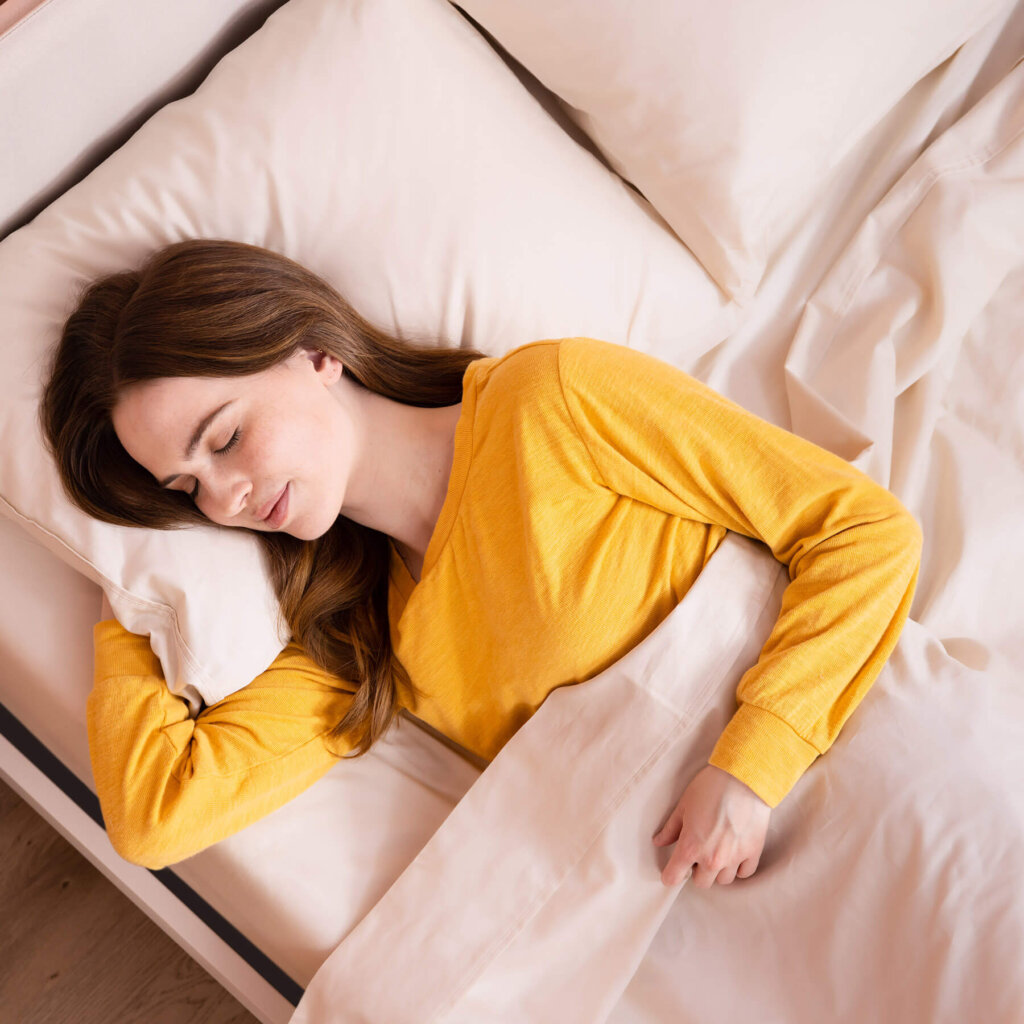 Woman sleeping in a bed fitted with Douglas Egyptian Cotton Sheets