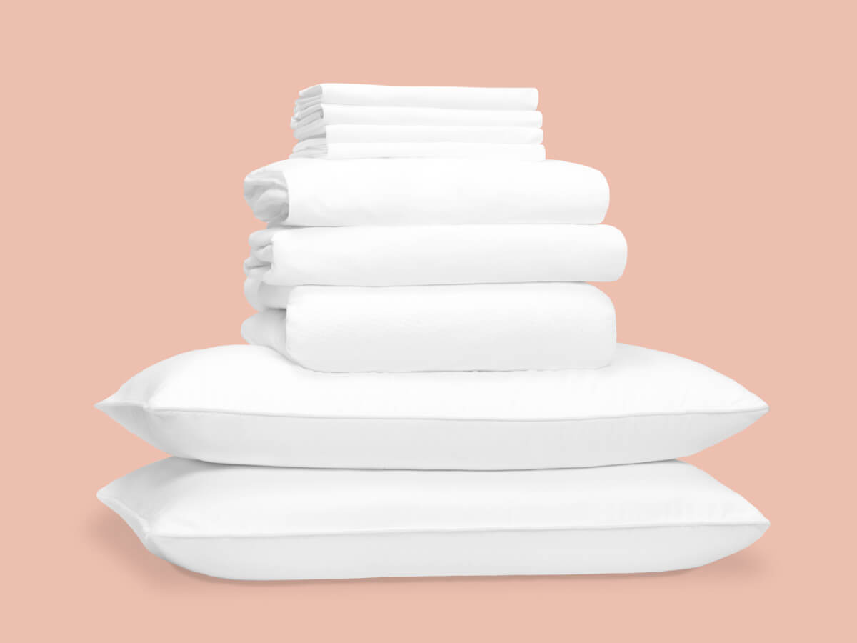 An attractive pile of pillows, sheets, and other free bedding