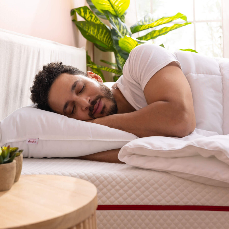 Man sleeping on his side on a Douglas Down Alternative Pillow