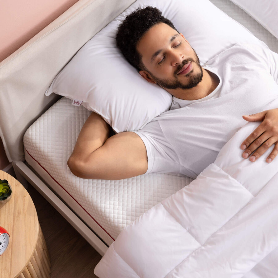 Man peacefully sleep on his back with Douglas Down Alternative Pillows